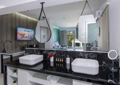 a bathroom with two sinks and a large mirror at xSuites - Adults Only Boutique Suites with Private Jacuzzi in Agia Marina Nea Kydonias