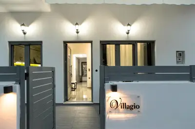a white house with a gate and lights at Villagio House in Falasarna