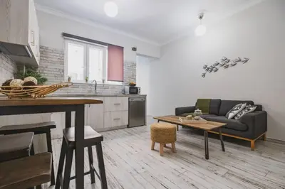 a kitchen and living room with a couch and a table at D&G Lux City Flat next to Old Town and Market in Chania Town