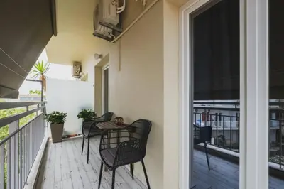 a patio with chairs and a table on a balcony at D&G Lux City Flat next to Old Town and Market in Chania Town