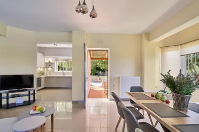 a kitchen and dining room with a table and chairs at Villa Moma in Palio Gerani