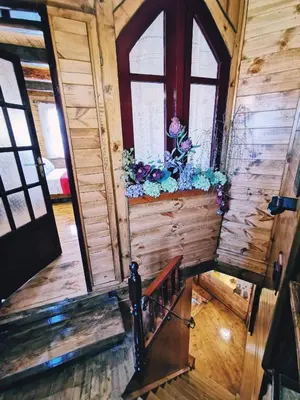 a stairway in a wooden house with flowers on it at Casa di Portou No3 in Chania Town