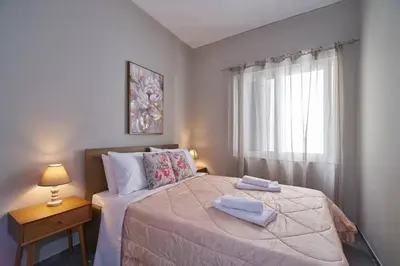 a bedroom with a bed with two towels on it at evgenia's city apartment in Chania Town