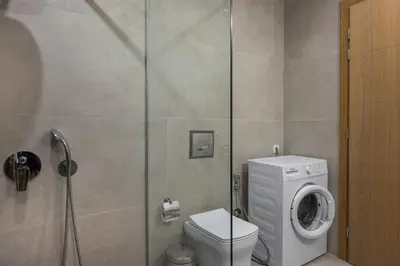 a bathroom with a toilet and a washing machine at Kolymbari Sea Front Cozy Apartments in Kolymvari