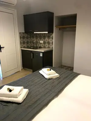 a bedroom with two white towels on a bed at Tasoula's Beachside Rooms in Palaiochóra