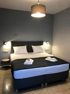 a bedroom with a bed with two towels on it at Tasoula's Beachside Rooms in Palaiochóra