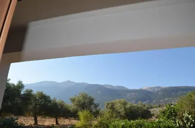 a view of the mountains through a window at Xenonas Anopolis 2 in Anopoli Sfakion