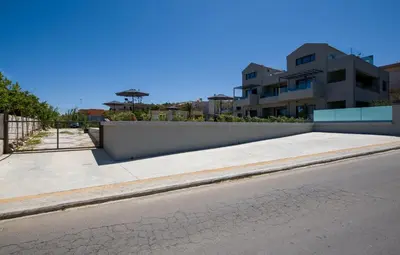 a sidewalk next to a street with a building at Eleanthi Modern Living in Galatás