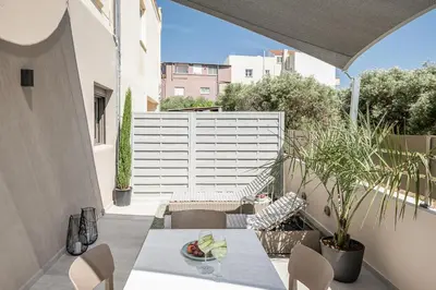 a patio with a table and chairs on a balcony at Margiani Studio & Apartment in Chania Town