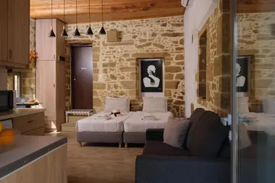 a living room with a bed and a couch in a room at Studio Batilas in Kaláthenai