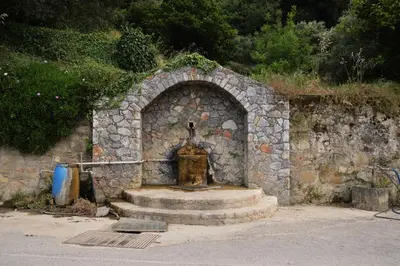 a stone archway with a fountain in a building at Studio Batilas in Kaláthenai