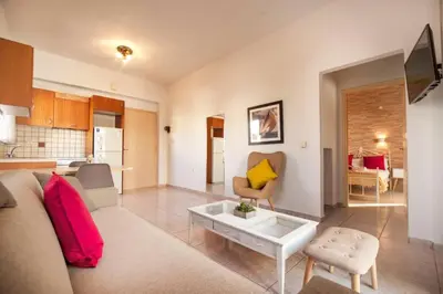 a living room with a couch and a table at jenny's flat near the sea in Galatás