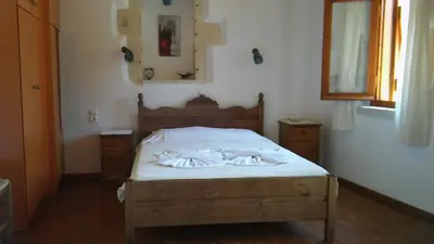a bedroom with a bed with two towels on it at Patriko Traditional Stone Houses in Vafés