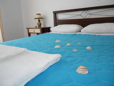 a blue bed with two shells on it at Kalyves Bay in Kalyves