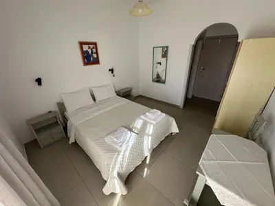 a bedroom with a bed in a white room at Filoxenia Studios 1 in Palaiochóra