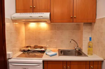 a kitchen with a sink and a stove at Filoxenia Studios 1 in Palaiochóra
