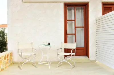 two chairs and a table on a patio at Filoxenia Studios 1 in Palaiochóra