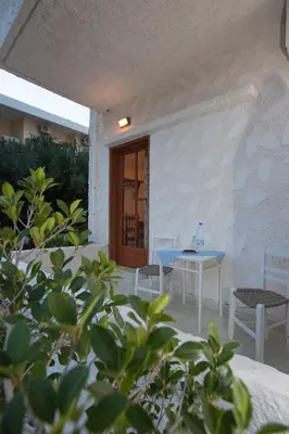 a table and chairs in front of a building at Filoxenia Studios 1 in Palaiochóra