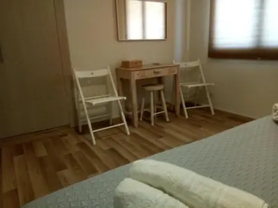 a bedroom with a desk and chairs and a table at Villa Anastasia in Kalamaki Chanion