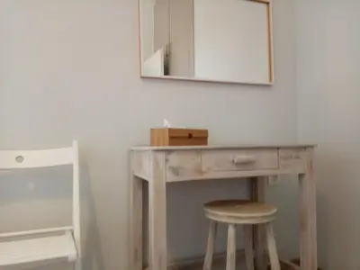 a wooden desk with a mirror and a stool at Villa Anastasia in Kalamaki Chanion