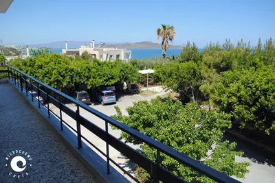 a balcony with a view of the water and trees at Villa Anastasia in Kalamaki Chanion