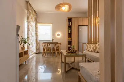 a living room with a couch and a table at Eden of grameno Luxury sea view apartment in Palaiochóra