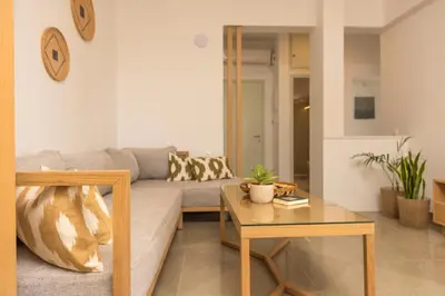 a living room with a couch and a table at Eden of grameno Luxury sea view apartment in Palaiochóra