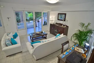 a living room with two couches and a table at *Haritos traditional Apt-5min from Falassarna Bch* in Kissamos
