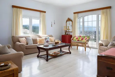 a living room with a couch and a table at Sunset Home with sea view in Chania Town