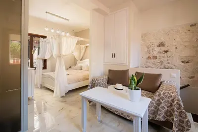 a living room with a couch and a bed at Chrisselen Palazzo Colombo in Chania Town