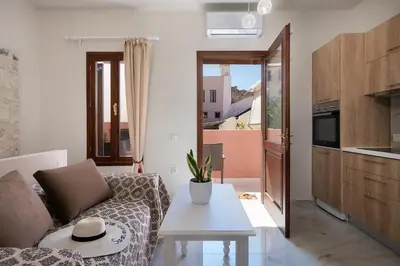 a living room with a couch and a table at Chrisselen Palazzo Colombo in Chania Town