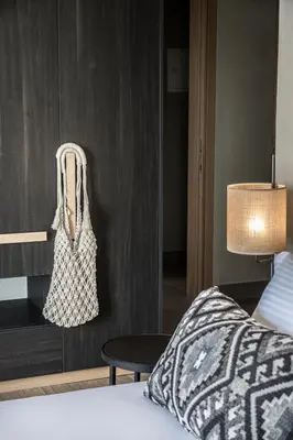 a bedroom with a bed and a table with a bag at panorama new generation in Sfakiá