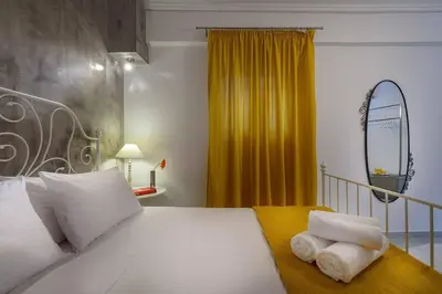 a bedroom with a bed with towels on it at Family home w. yard in Beating Heart of Old Town in Chania Town