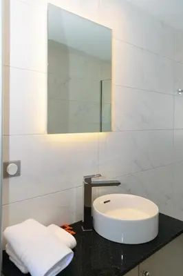 a bathroom with a sink and a mirror at Katakis LuxuryVillas in Chania Town