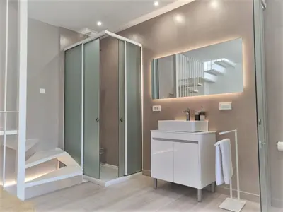 a bathroom with a sink and a shower and a mirror at Valentina's Luxury House in Chania Town