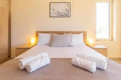a bedroom with a bed with two white towels on it at Cretan fleur apartments in Elafonisi
