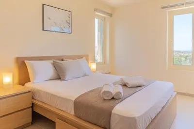 a bedroom with a bed with two slippers on it at Cretan fleur apartments in Elafonisi