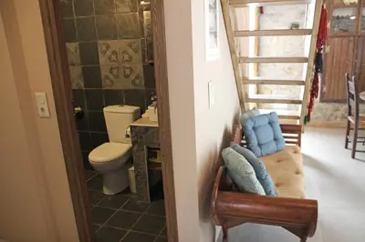 a bathroom with a toilet and a stair case at Laini Guest Houses in Koulkouthianá