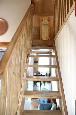 a staircase in a house with wooden walls at Laini Guest Houses in Koulkouthianá