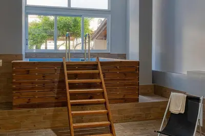 a wooden bar in a room with a window at Villa Hope in Chania in Mourniaí