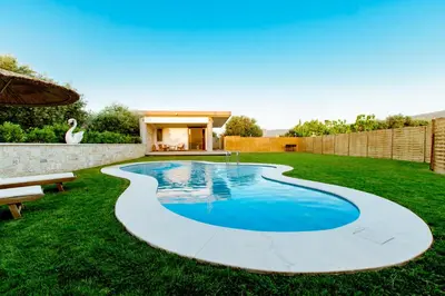 a swimming pool in the yard of a house at Chania Oasis with heated pool in Chania Town
