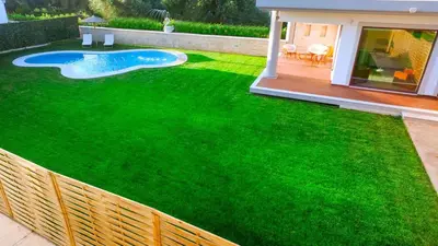 a fake grass yard with a swimming pool on it at Chania Oasis with heated pool in Chania Town
