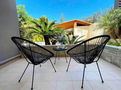 two chairs and a table on a patio at Artdeco Luxury Suites in Korakiaí