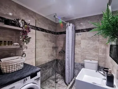 a bathroom with a shower and a sink at Rocky Mountain Villa in Ramní