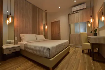 a bedroom with a bed and a desk and a sink at Gonis Grand Luxury Suite in Palaiochóra