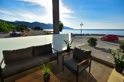 a living room with a couch and a view of the ocean at Gonis Grand Luxury Suite in Palaiochóra