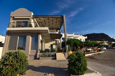 a building with a balcony on top of it at Gonis Grand Luxury Suite in Palaiochóra