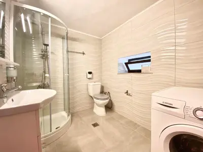 a white bathroom with a toilet and a sink at PRIMAVERA in Kalamaki Chanion