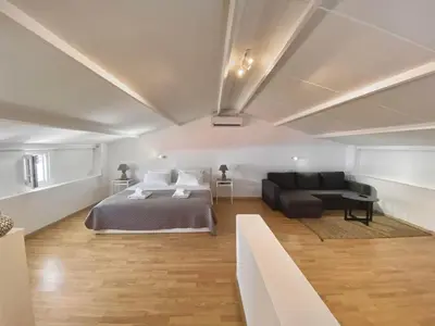 a bedroom with a bed and a couch at PRIMAVERA in Kalamaki Chanion
