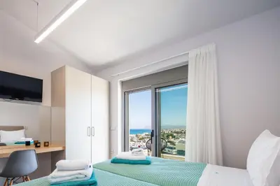 a bedroom with a bed and a large window at Centro Golden View Villa in Chania Town